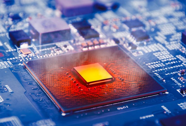 The computer processor CPU overheating and smokes around on computer motherboard, blue logic board with microprocessor.