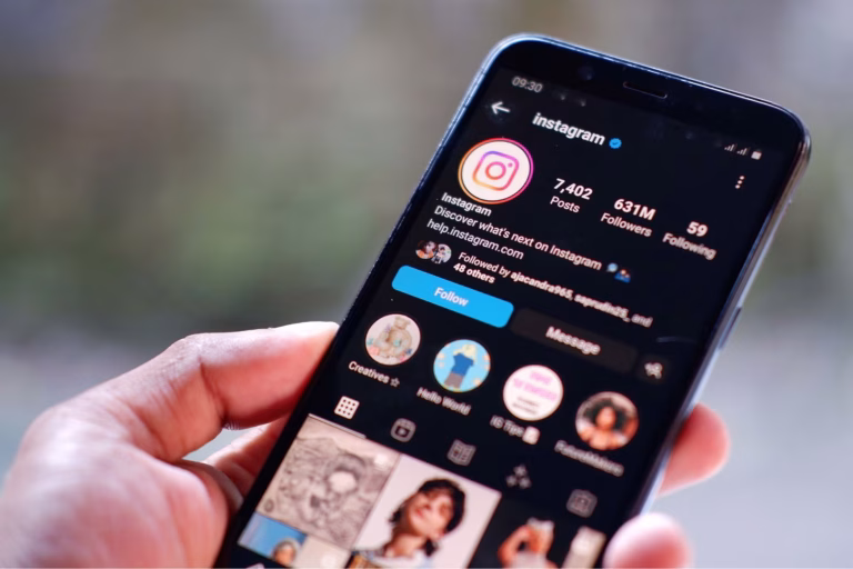 a-hand-holding-a-smartphone-with-an-instagram-account-on-the-screen