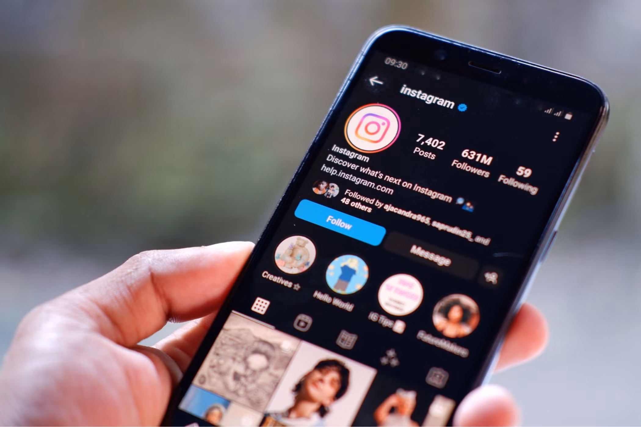 a-hand-holding-a-smartphone-with-an-instagram-account-on-the-screen