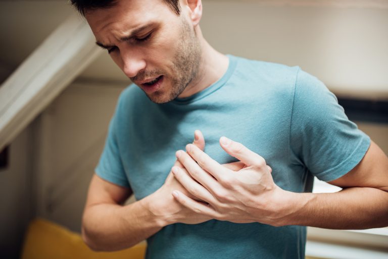 Ill man holding his chest