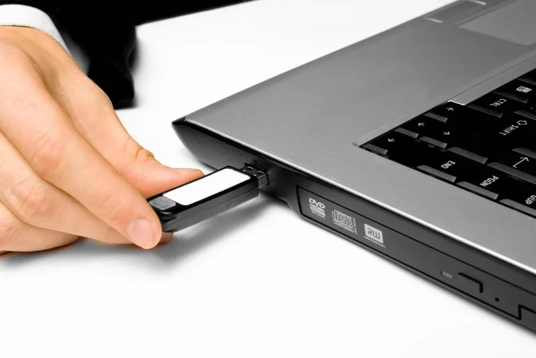 hand-inserting-flash-drive-into-laptop-computer