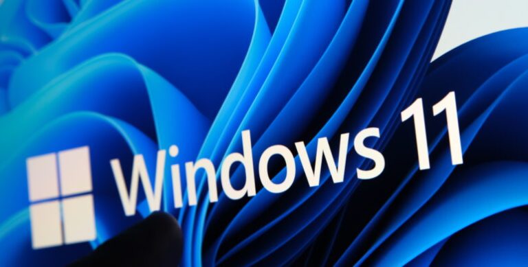 Windows 11 logo seen on the screen of tablet and user pointing a
